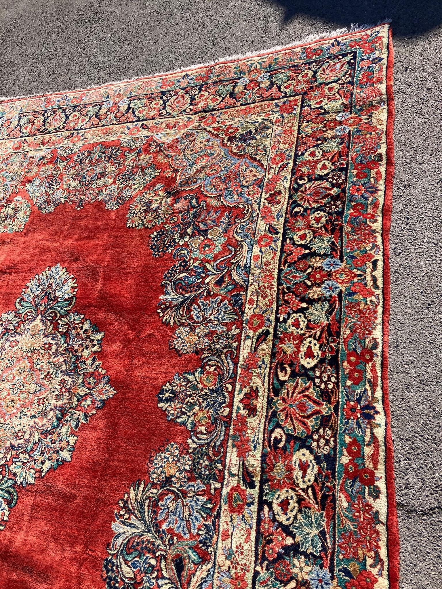 A large North West Persian red ground carpet, 361cm x 274cm